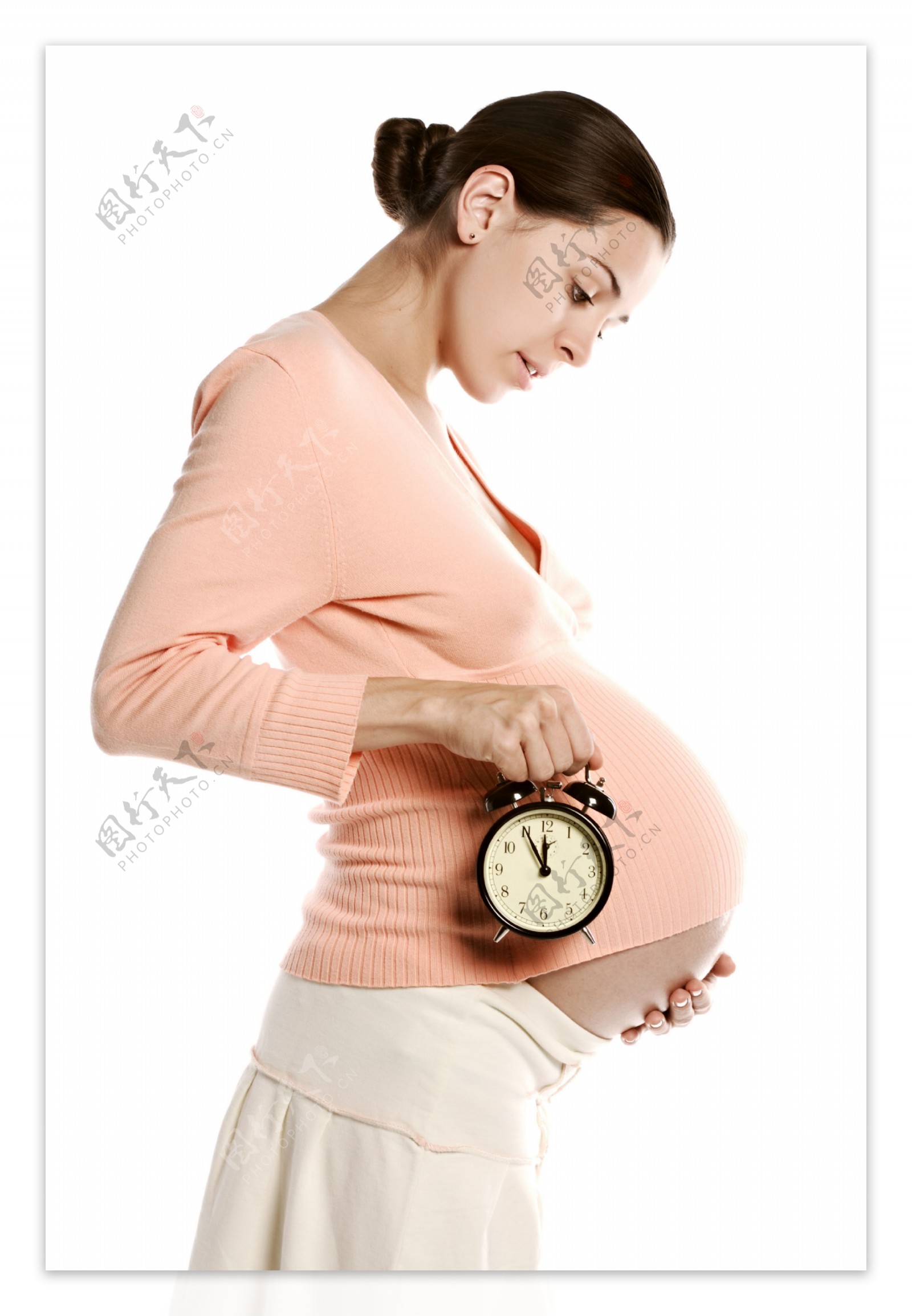 手拿闹钟的孕妇图片